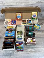 Photo showing large quantity of loose cards in box with multiple sealed vintage baseball card boxes on top and nearby
