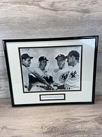 Full view of framed print showing four New York Yankees players holding baseball bats.