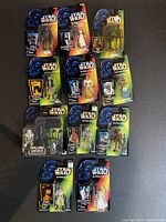 Photo showing all 12 sealed Star Wars action figures laid out on a surface in original packaging