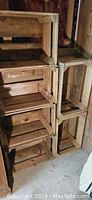 Stacked wooden slat boxes showing their size and shape variety with clear view of slatted construction and wood condition.