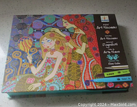 Closed box of the Art Nouveau inspired art set featuring stylized female figures in ornamental patterns on the cover with branding.