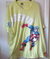 Full front view of the light yellow Captain America Marvel Comics T-shirt with large Captain America graphic and LEGEND text.
