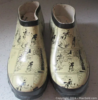 Front view of the pair of Disney clogs with cartoon strip design featuring Mickey and Goofy