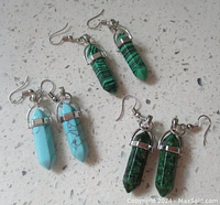 View of all three pairs of crystal earrings showing turquoise, red green jasper, and malachite stones in silver-tone metal settings.