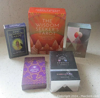 Photo of all five tarot decks showing box designs and relative sizes