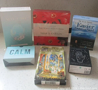 Six oracle card decks arranged together on a white surface, showing all box fronts readable.