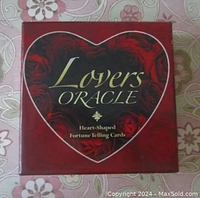 Front of the red box with heart shape and title Lovers Oracle Heart-Shaped Fortune Telling Cards