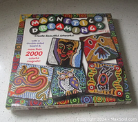 Photo of the front closed box showing the Magnetic Dreamings Indigenous Art Kit packaging with examples of completed artworks.