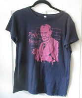 Navy blue T-shirt with pink graphic of Sigmund Freud holding a cigarette in front of a brick wall, with text 'Pink Freud' on left side.