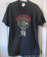 Full front view of black Roger Hodgson t-shirt with red and yellow dreamcatcher graphic