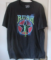 Full view of black Rush t-shirt with colorful 2112 album cover graphic