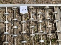 Close-up image showing the aluminum frame and rows of metal rollers attached to axles.