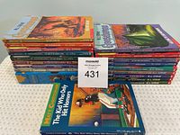 Stack of colorful Goosebumps and Matt Christopher paperback books with visible titles and illustrated covers