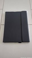 Closed black large tablet case with fold-over flap