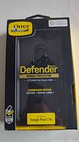Front packaging of OtterBox Defender Series Rugged Protection case for Google Pixel 2 XL, showing yellow and black design, brand logo, and model compatibility.