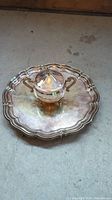 Photo of the silver-plated serving tray with the lidded sugar bowl placed in the center, showing the scalloped edge and reflective surface.