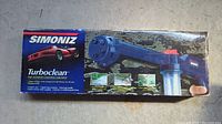 Box front showing Simoniz Turboclean product and features with blue cleaning tool image and red sports car graphic.