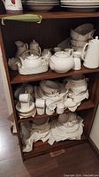 Shelves holding the full set of porcelain pieces