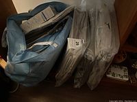 Photo of the blue Eco Fabric fabric swivel organizer with multiple shelves and packaged items inside.