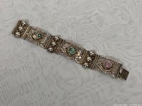 Overview image of full 7-inch vintage Mexican sterling silver bracelet showing linked segments with abalone shell accents and silver ball detailing.
