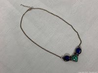 Full view of the choker necklace showing chain and centerpiece with stones.