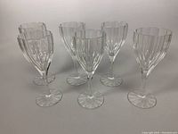 Front view showing six Nachtmann crystal wine goblets with vertical faceted design, standing upright.