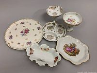 Overview photo showing all 6 pieces including the floral German cake plate, Limoges tray, butterfly dish, and pedestal compote dishes.