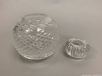 Photo showing both the orb vase and the smaller votive candleholder side by side on a neutral surface.