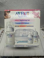 Front view of box showing the contents of the Avent Naturally Great Beginnings Set including bottles, sterilizer, pacifiers and brush.