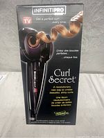 Front view of the Conair InfinitiPro Curl Secret curling iron box showing product image, name, and key features including creating perfect curls every time.