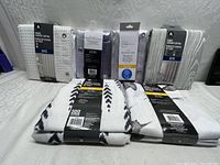 All six shower curtains in original packaging showing variety and condition