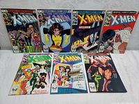 Seven X-Men comic books laid out showing front covers