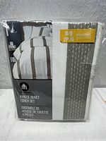 Front view of packaged HomeTrends 4-piece duvet cover set, double/queen size, showing product information and partial image of design pattern.