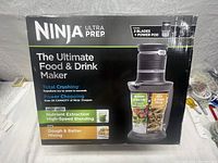 Front view of the Ninja Ultra Prep box highlighting the product features and capabilities including total crushing, power chopping, nutrient extraction, and dough mixing.