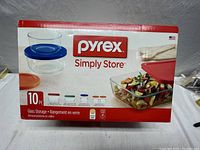 Front view of box showing Pyrex Simply Store 10-piece glass storage set, includes images of glass containers with lids and text with capacities.