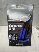 Front of box showing the Turbo ExtremeSteam handheld steamer and iron, highlighting steam power and turbo mode.