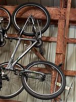 Full view of Giant Rincon mountain bike hanging in garage showing frame, tires, and handlebars.
