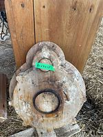Wood foundry mold pattern with oval shape and metal ring insert seen from the front.