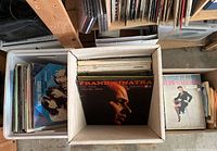 Three boxes of vinyl records displayed showing various album covers including Frank Sinatra and Judy Garland