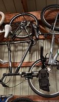 Side view of Gary Fisher bicycle hanging in storage with visible wheels, frame, seat, and handlebar.