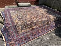 Full view of the rug laid out on deck under sunlight