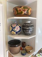 Three-tier shelf showing all eight ceramic and decorative items.