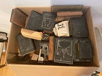 Overall lot of mixed wooden and metal printing blocks arranged in cardboard box