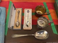 Overview of three spoons and two cups arranged on table