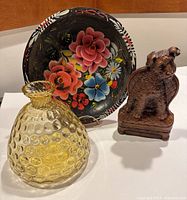 Photo showing all three items: Mexican wooden batea bowl, yellow Murano glass bottle, terrier dog bookend