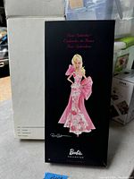 Front view of the Barbie Collector box showing the Barbie doll in a pink gown with floral and bow design.