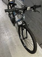 Front view of the Huffy mountain bike showing gray and blue frame, front tire, and handlebars.