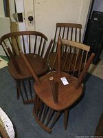 Cluster of all five chairs, one upside-down showing underside and leg positions