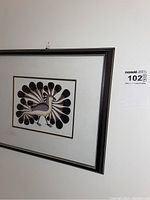 Full view of framed Inuit art print hanging on wall