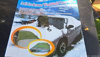 Photo of the product packaging showing the windshield cover on a snowy car with instructions and features.